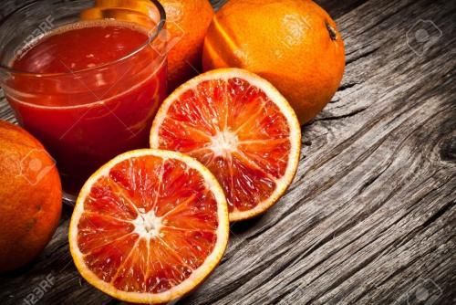 11092857-fresh-Sicilian-orange-juice-tarot-on-wood-Stock-Photo.jpg